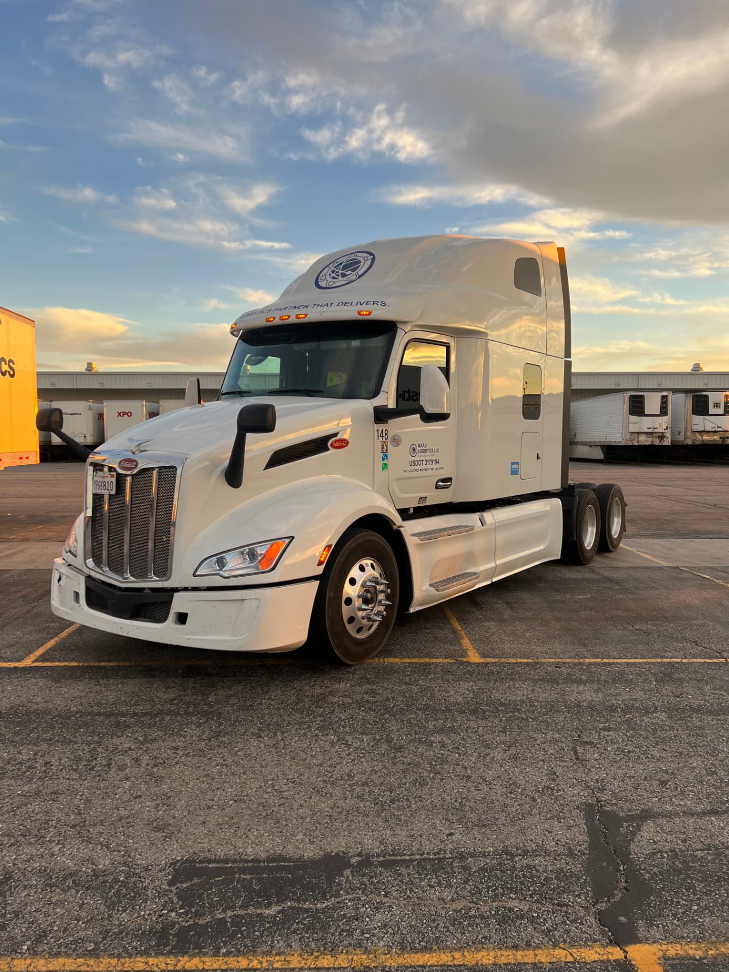 Maas Logistics Peterbilt 579 sleeper tractor staged at a dry van dock