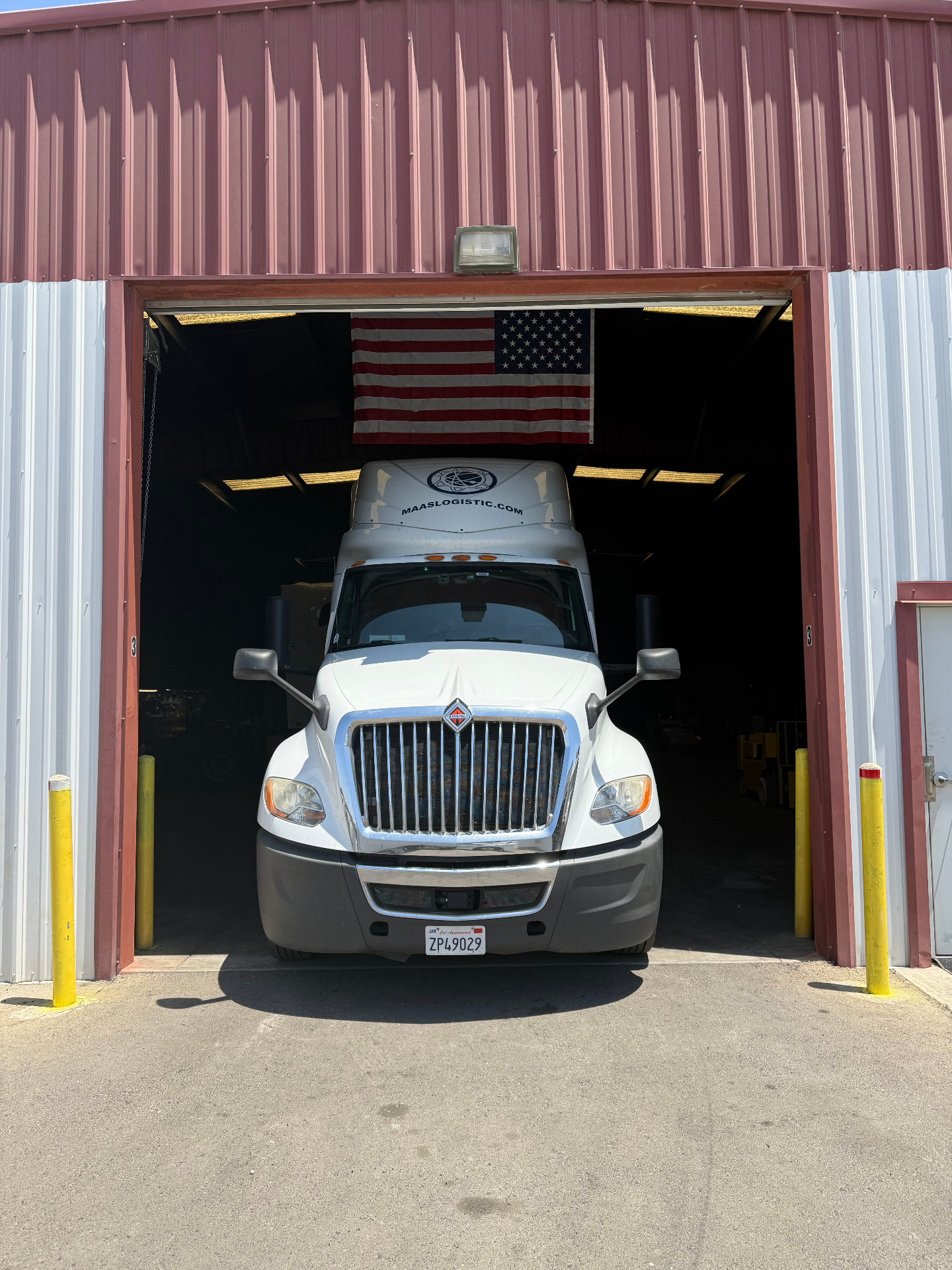 Maas Logistics International tractor pulled into the company maintenance shop bay